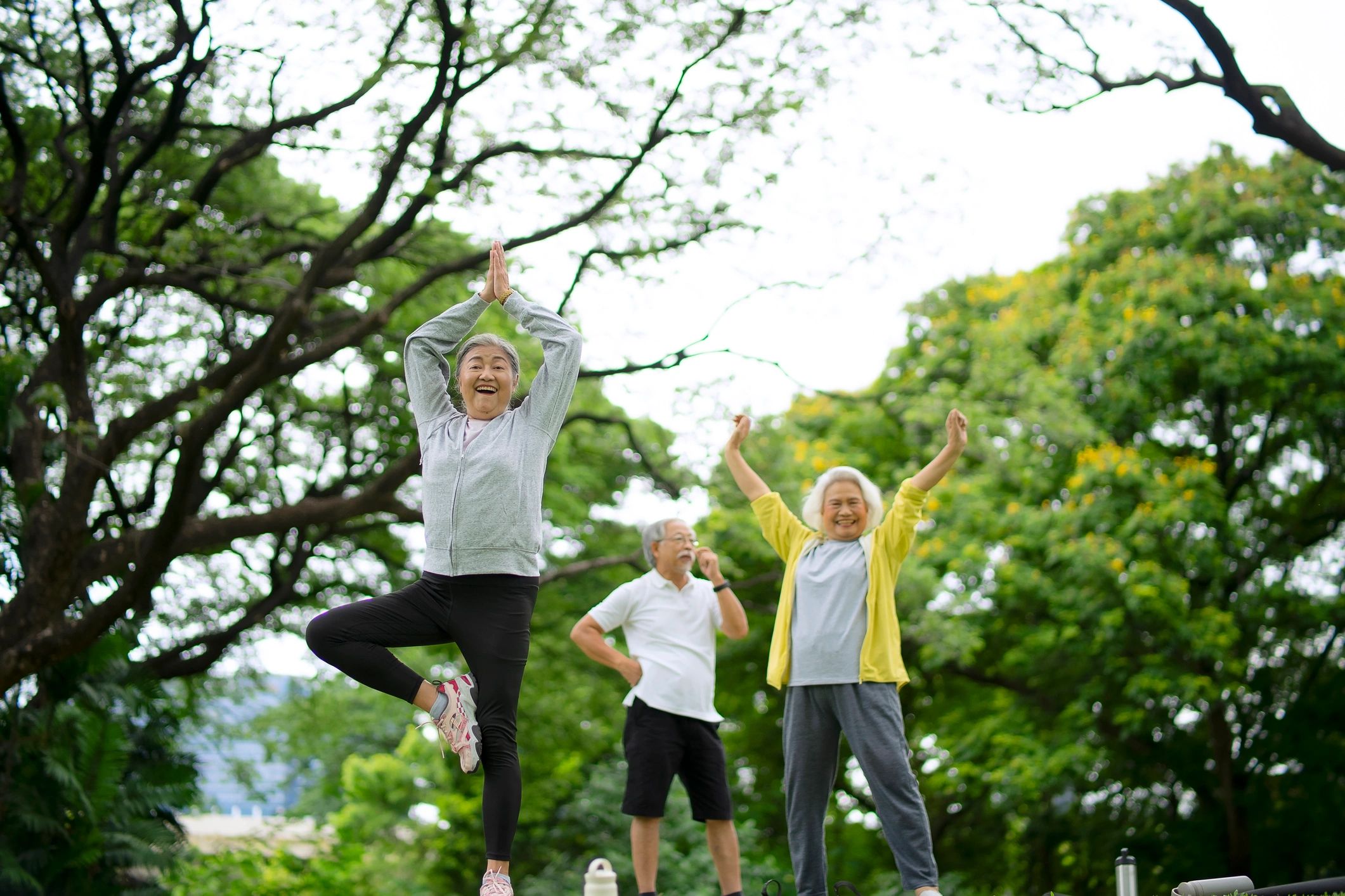 Group yoga class practicing together outdoors